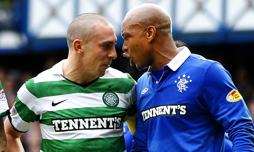Celtic's Brown talks with Rangers' Diouf during their Scottish Cup soccer match in Glasgow